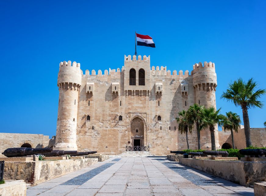 Citadel of Qaitbay with Egyptian flag flying above it in Alexandria- Egypt