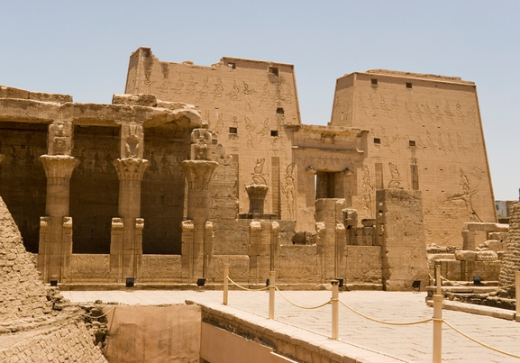 high wall front facade of Egyptian Edfu Temple of falcon god Horus, with carving figures and hieroglyphs, in Egypt, Africa