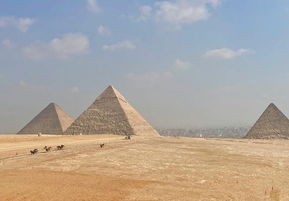Stunning view of the Pyramids of Giza sand and sky in Egypt Africa