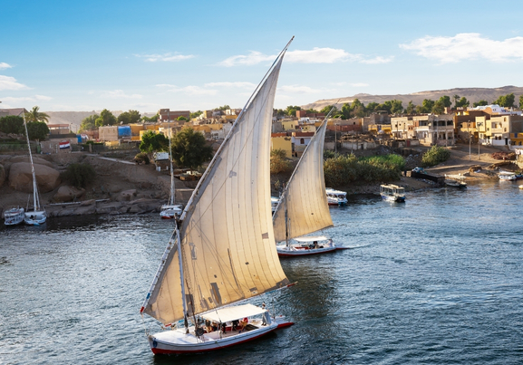 Sailboats on Nile river at sunset in Aswan egypt
