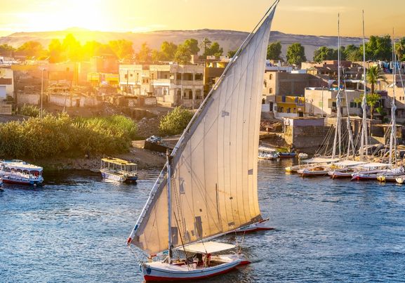 Aswan and Boats in a Blue Scenic River and sunset