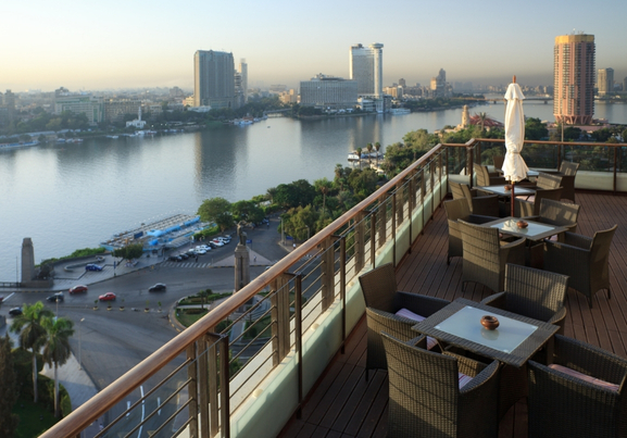 Aerial View Of Nile River With Cityscape On Balcony With Table And Chairs In Morning In Cairo In Egypt