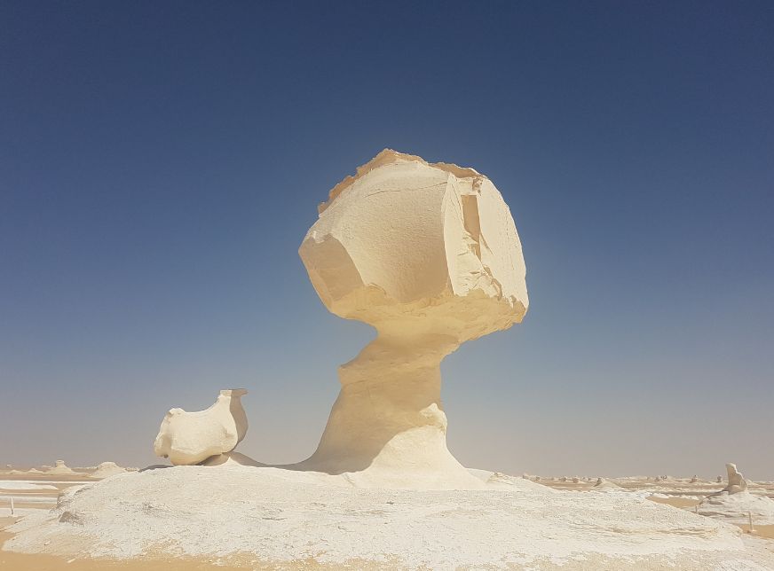 a wind craved, chalk-rock formation called "Egg & Chicken", which sits on a plain inside the White Desert
