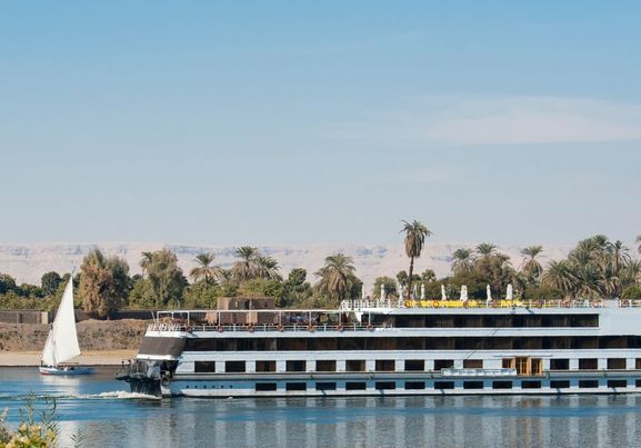Nile river boat cruising through Luxor in sunny day